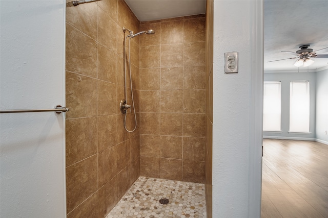 bathroom featuring a tile shower, ceiling fan, and hardwood / wood-style floors