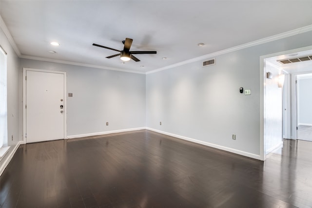 spare room featuring dark hardwood / wood-style flooring, ceiling fan, and crown molding