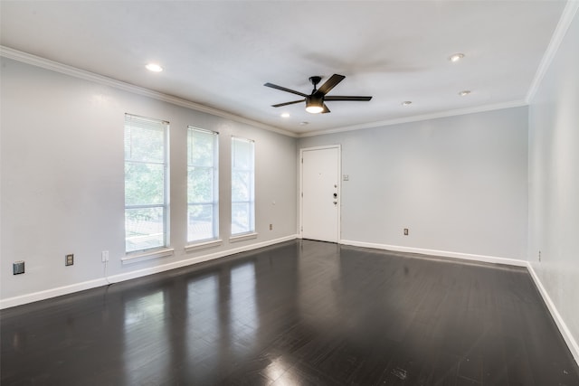 spare room featuring dark hardwood / wood-style floors, ceiling fan, and ornamental molding