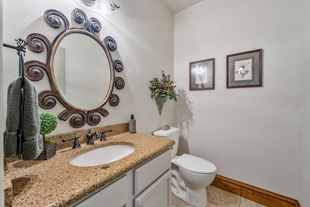 bathroom featuring tile patterned flooring, vanity, and toilet