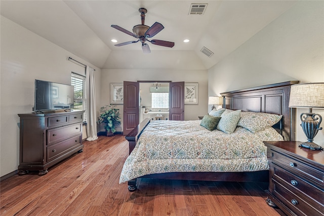 bedroom featuring ceiling fan, light hardwood / wood-style flooring, and lofted ceiling