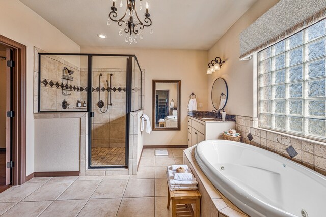 bathroom featuring tile patterned floors, vanity, plus walk in shower, and a notable chandelier