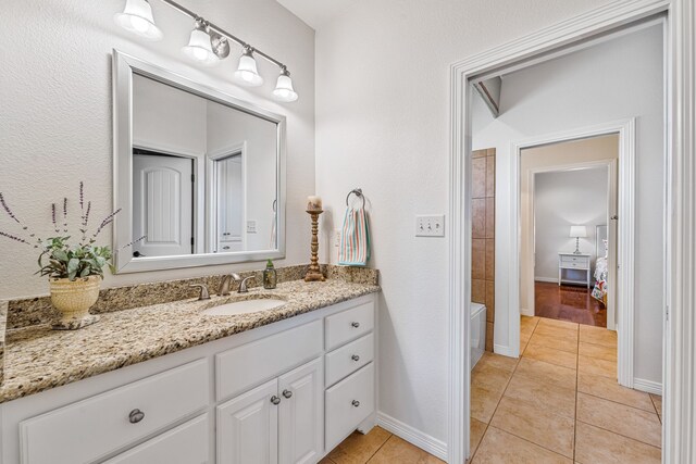 bathroom featuring tile patterned flooring and vanity