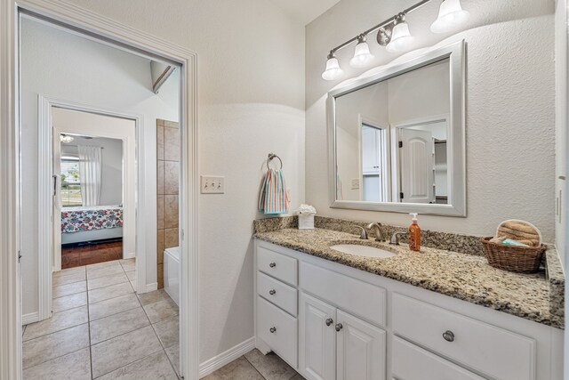 bathroom featuring tile patterned flooring and vanity