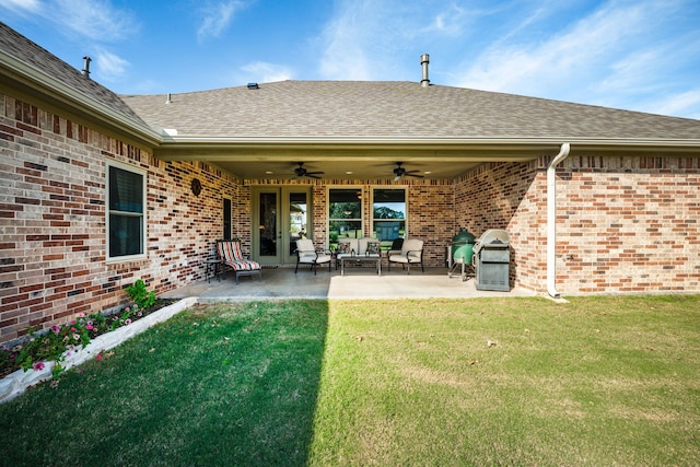 rear view of house featuring ceiling fan, french doors, a yard, an outdoor hangout area, and a patio