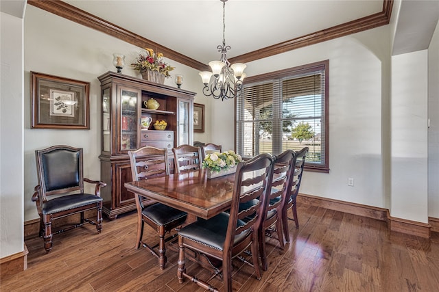 dining room featuring a fireplace, dark hardwood / wood-style floors, an inviting chandelier, and crown molding