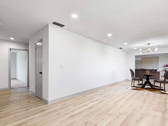 dining room featuring light hardwood / wood-style floors and a notable chandelier