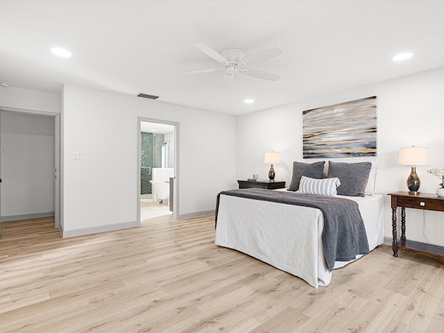 bedroom featuring ceiling fan, ensuite bathroom, and light hardwood / wood-style flooring