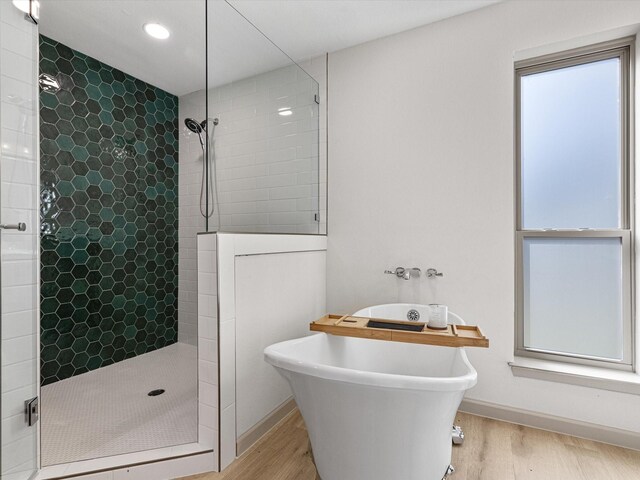 bathroom featuring shower with separate bathtub and hardwood / wood-style flooring