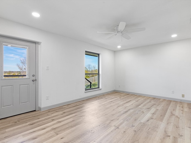 unfurnished room with ceiling fan and light wood-type flooring