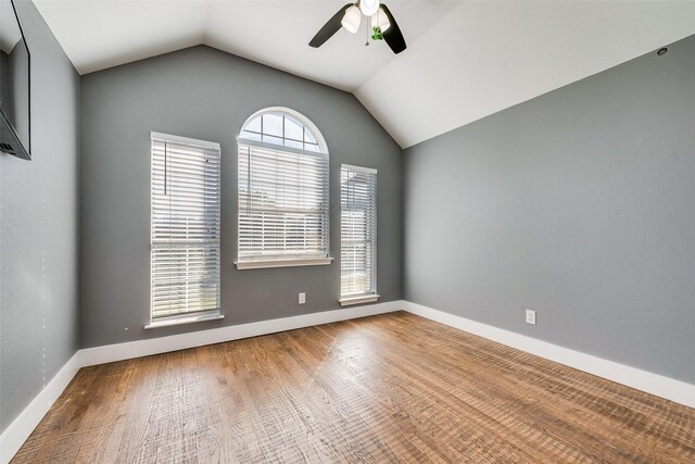 spare room with hardwood / wood-style flooring, ceiling fan, and lofted ceiling