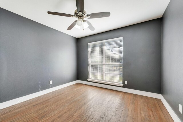 spare room featuring ceiling fan and hardwood / wood-style flooring