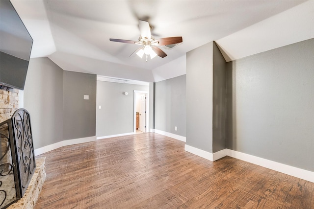 unfurnished living room featuring ceiling fan, a fireplace, wood-type flooring, and lofted ceiling