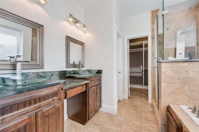 bathroom featuring tile patterned floors, vanity, and a shower with shower door