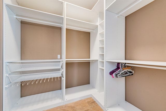 walk in closet with tile patterned floors