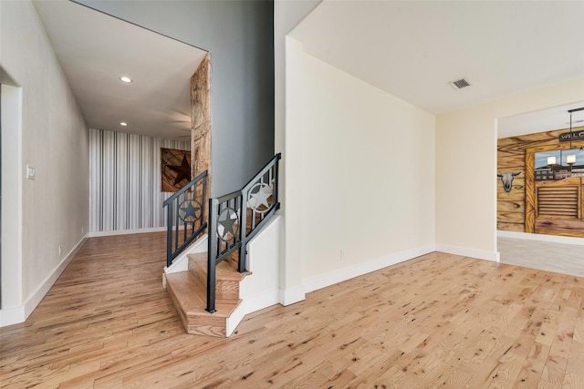 interior space with wooden walls and hardwood / wood-style floors