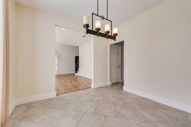 unfurnished dining area with light hardwood / wood-style flooring and a notable chandelier