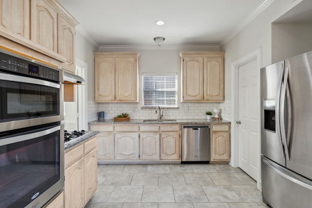 kitchen featuring appliances with stainless steel finishes, crown molding, light brown cabinetry, and sink