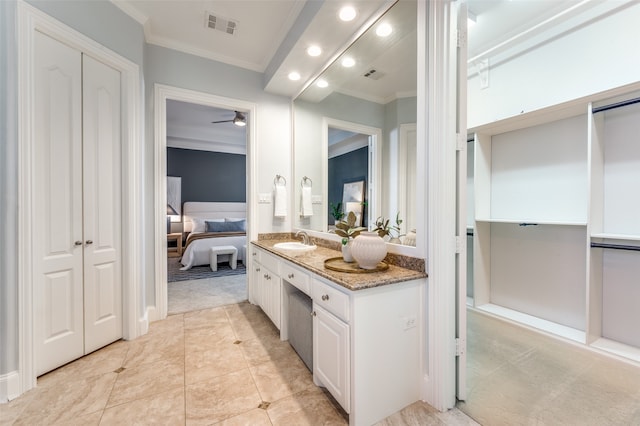 bathroom with ceiling fan, tile patterned flooring, vanity, and ornamental molding