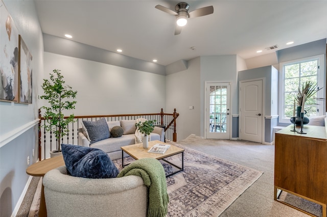 living room featuring ceiling fan and carpet