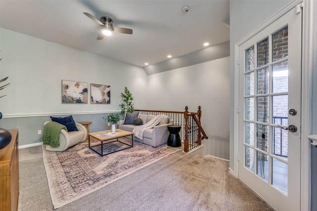 carpeted living room featuring ceiling fan