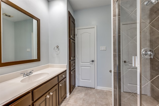 bathroom with tile patterned flooring, vanity, and an enclosed shower