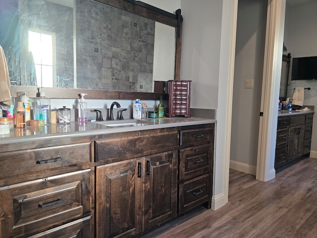 kitchen featuring dark brown cabinets, dark hardwood / wood-style floors, and sink