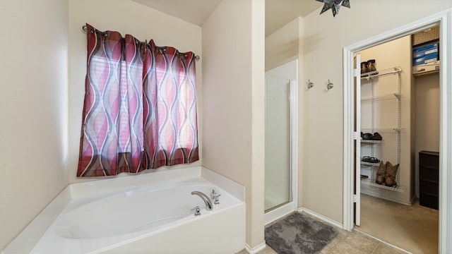 bathroom with shower with separate bathtub and tile patterned floors