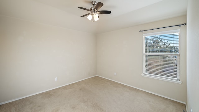 carpeted empty room featuring ceiling fan