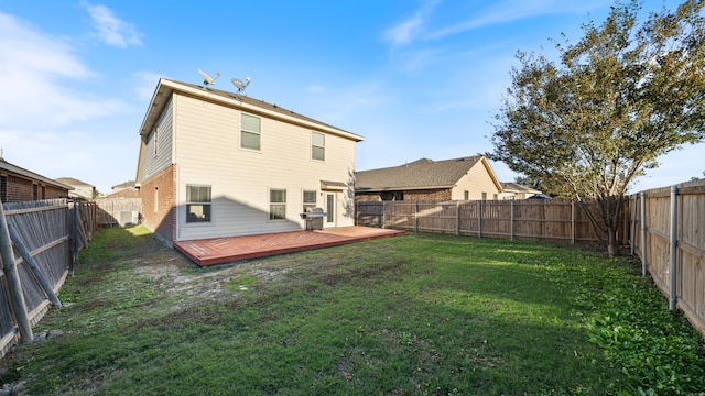 back of property featuring a yard and a deck