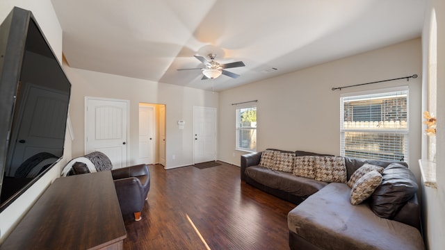 living room with dark hardwood / wood-style flooring and ceiling fan