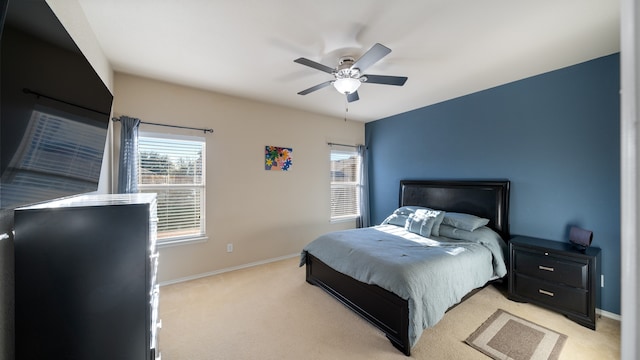 bedroom featuring light carpet and ceiling fan