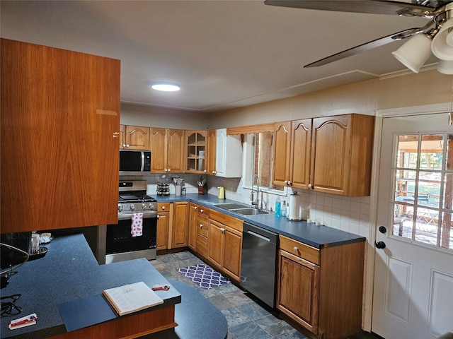 kitchen with ceiling fan, appliances with stainless steel finishes, sink, and decorative backsplash