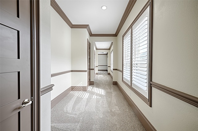 hall featuring light colored carpet and ornamental molding