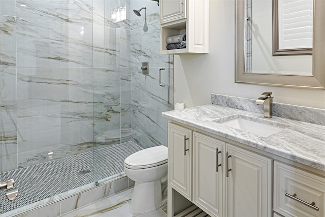 bathroom featuring vanity, toilet, and a shower with door