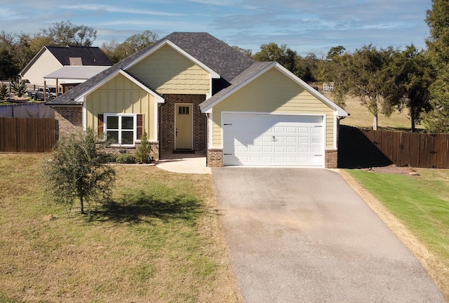 view of front of property featuring a garage and a front yard