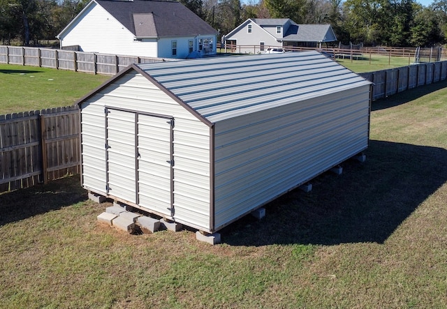 view of outdoor structure featuring a lawn