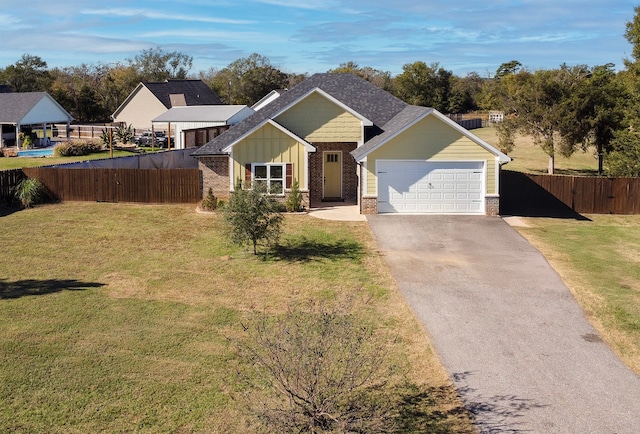 view of front of house with a front yard and a garage