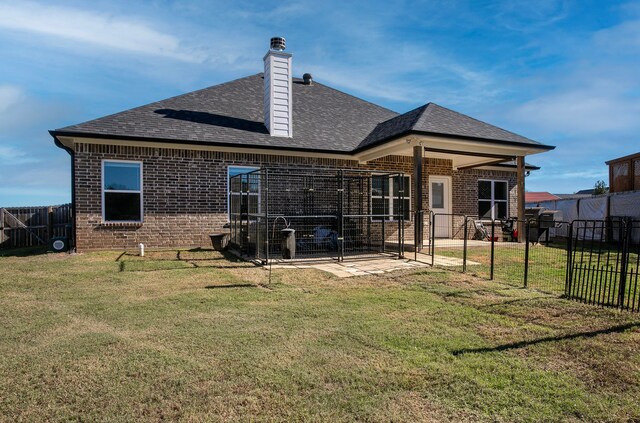 rear view of property with a lawn