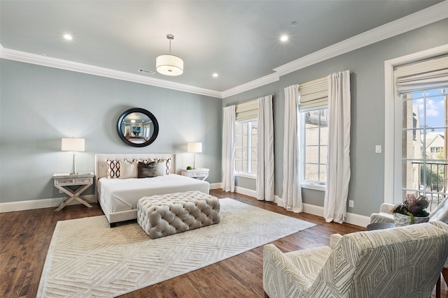 bedroom with multiple windows, baseboards, and wood finished floors