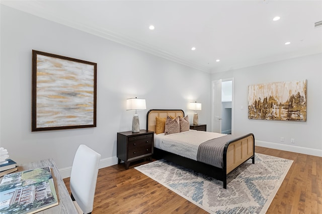 bedroom with recessed lighting, baseboards, and wood finished floors