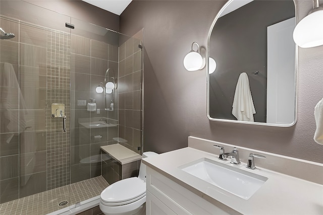 full bathroom featuring toilet, a shower stall, and vanity