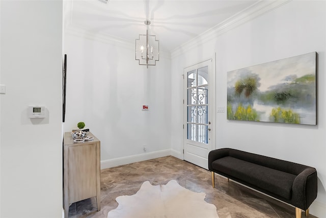 entrance foyer featuring ornamental molding, an inviting chandelier, and baseboards