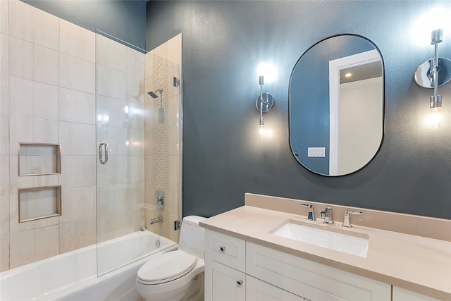 bathroom with washtub / shower combination, vanity, and toilet