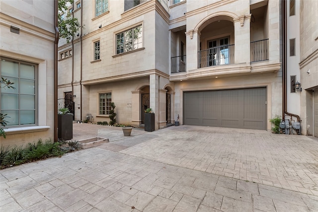 view of front of property with a garage and decorative driveway