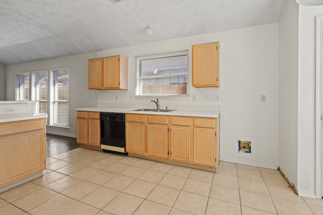 kitchen featuring light brown cabinets, dishwasher, sink, a textured ceiling, and light tile patterned flooring