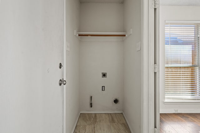 clothes washing area featuring hookup for an electric dryer, hardwood / wood-style floors, and a wealth of natural light