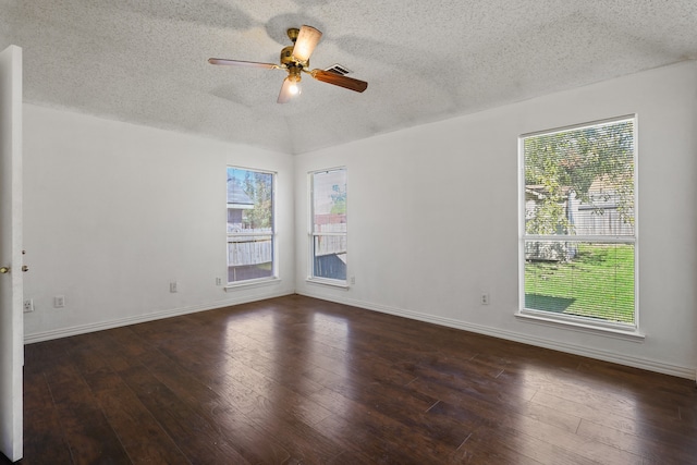 spare room with a textured ceiling, dark hardwood / wood-style floors, and ceiling fan