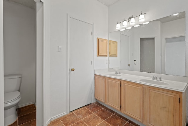 bathroom featuring tile patterned floors, vanity, and toilet