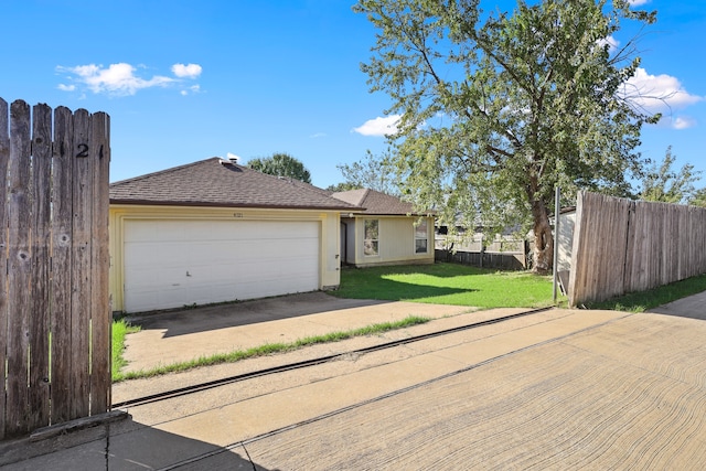 view of front of house with a front yard and a garage